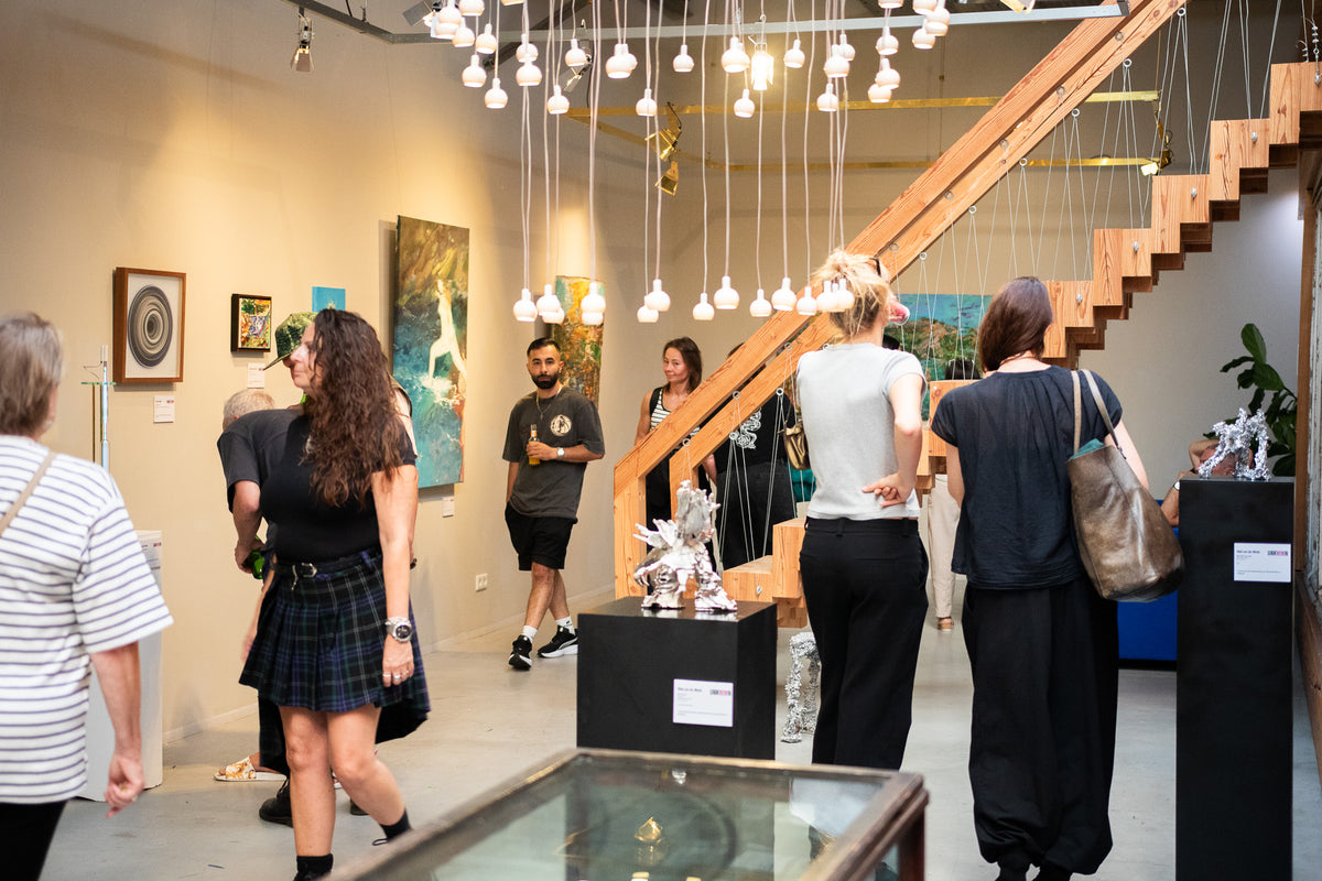 Visitors viewing art at UNKnowN Art Gallery during Together in Spirit